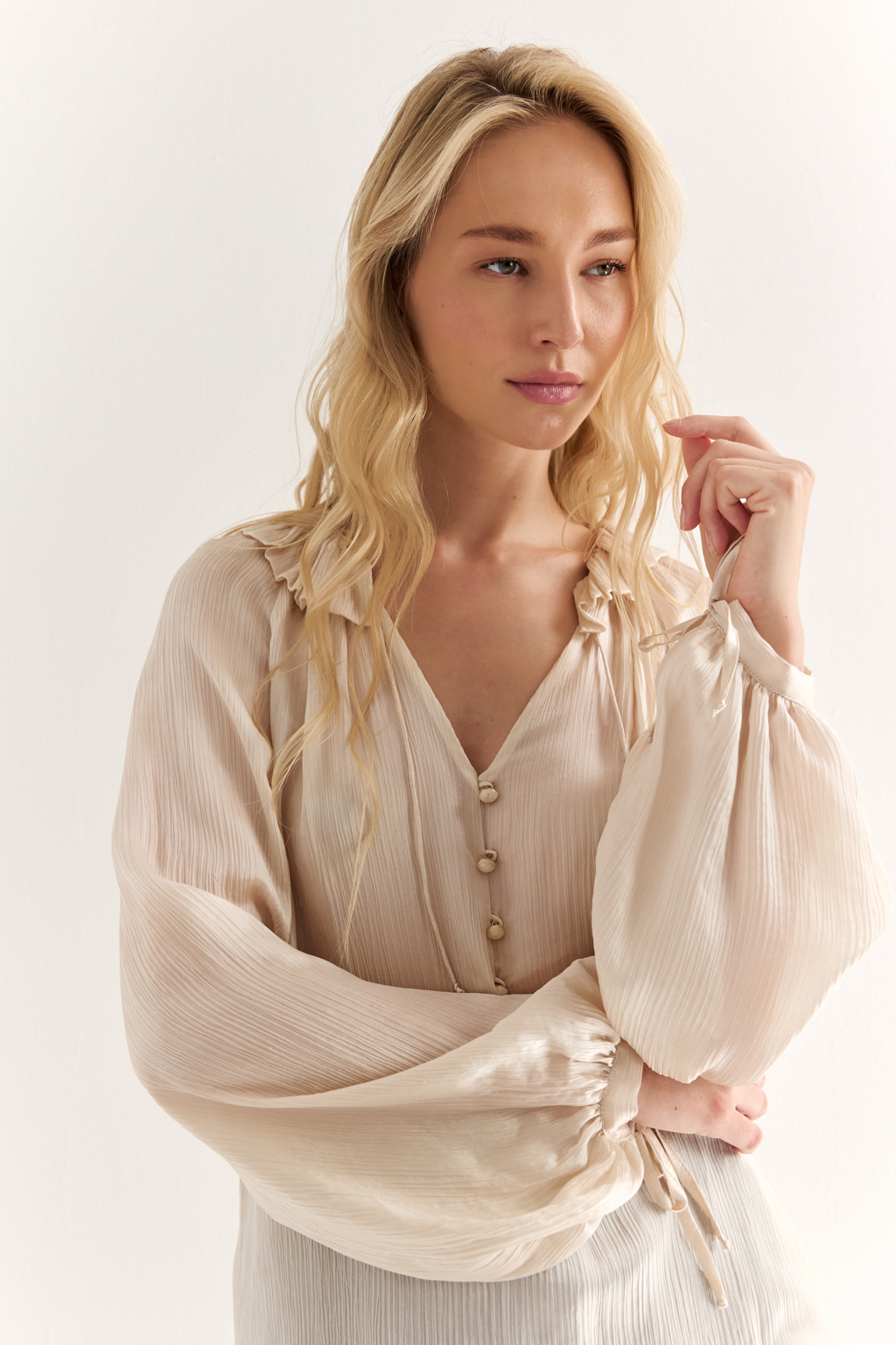 Блуза из 100% шёлка: воздушная элегантность с характером. Эта блуза создана из натурального шёлка — благородной ткани, которая буквально скользит по коже и придаёт образу утончённость. Объёмные рукава с  завязками создают лёгкий силуэт, а мягкая рюша по линии горловины добавляет динамики и изящества. Прямой крой обеспечивает комфорт и универсальность: блуза легко адаптируется под офисный стиль, романтичные образы или вечерние выходы. Носите с классическими брюками, юбками или джинсами — она всегда выглядит достойно. Чистый шёлк. Чистая элегантность.