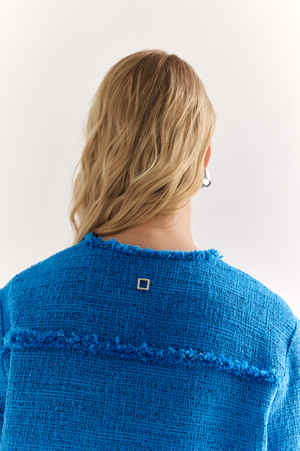 Жакет в стиле Chanel: текстура, изящество, характер
Икона стиля в современной интерпретации — укороченный жакет с застёжкой на крючки и декоративной бахромой по краям. Круглый вырез, слегка расклешенный силуэт и акцентные накладные карманы формируют элегантную геометрию, а текстурная отделка добавляет образу артистичной дерзости.
Эта модель легко становится центральным элементом образа — носите с юбкой, брюками или даже джинсами, создавая контраст между фактурой и формой. Идеальный выбор для женственного, но уверенного стиля.
Современная классика с французским акцентом.