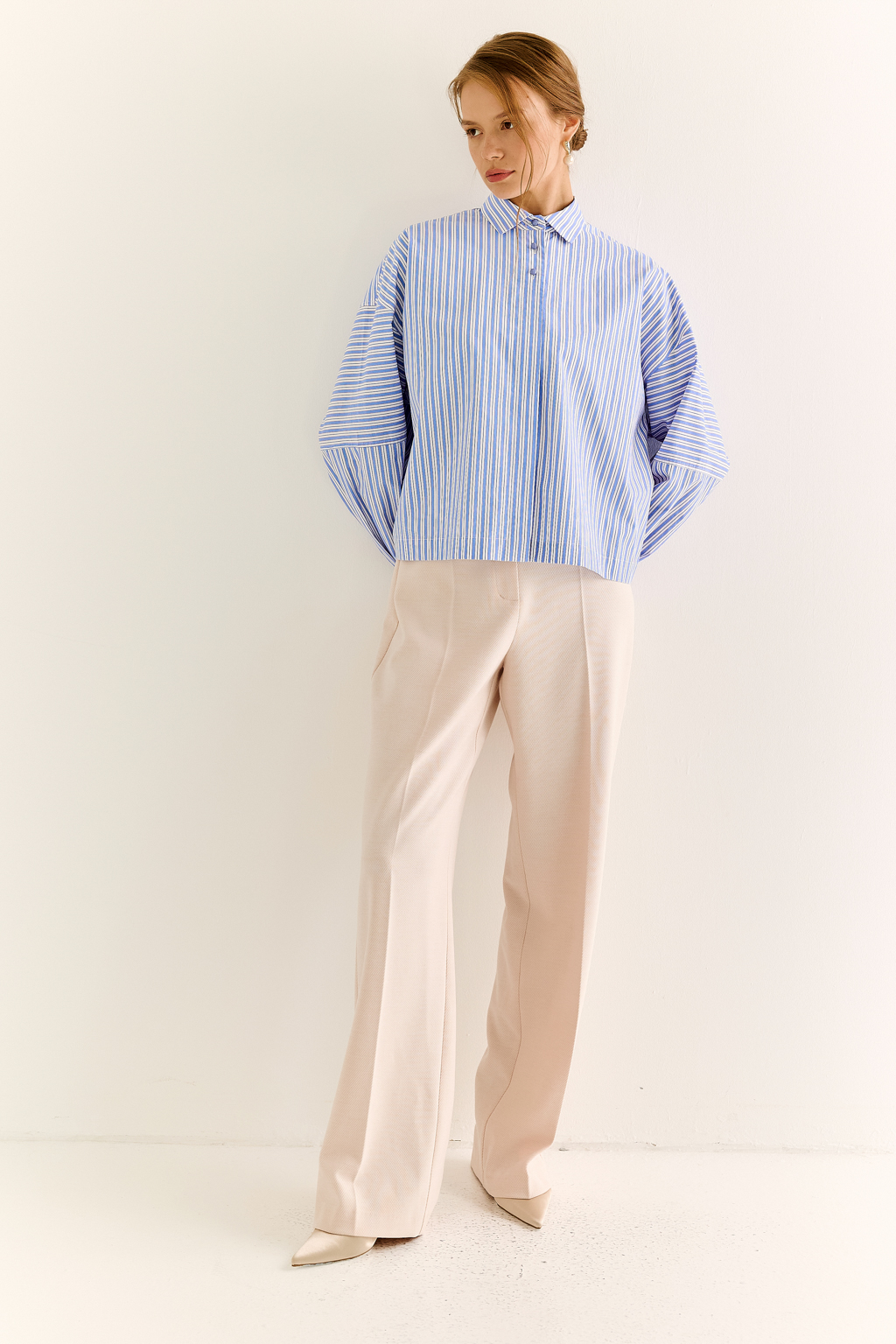 Oversize-рубашка: свобода в форме, точность в деталях
Эта укороченная oversize-рубашка — воплощение современного кроя и функционального стиля. Объёмные рукава с манжетами, акцентная застежка и выразительная спинка с декоративными элементами придают образу архитектурность и остроту. Маленький воротник и прямой крой делают модель универсальной — от smart casual до модного street style.
Носите как самостоятельную вещь или как верхний слой поверх топа и платья. Особенно эффектно сочетается с брюками-карго, юбкой на высокой талии или джинсами.
Для тех, кто выбирает стиль с воздухом