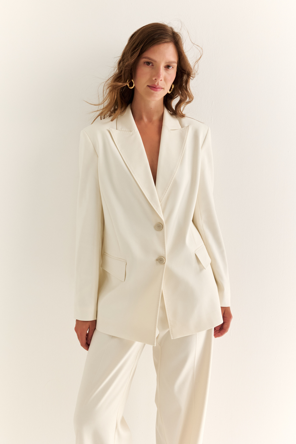 Жакет прямого силуэта: сдержанная элегантность и статусный акцент. Прямой крой, чёткие плечи и удлинённая линия делают этот жакет универсальной базой для гардероба современной женщины. Эффектные заострённые лацканы и глубокий V-образный вырез создают вытянутый силуэт, визуально стройнящий и придающий образу собранности. Застёжка на две пуговицы подчёркивает лаконичность формы, а прорезные фигурные клапаны карманов добавляют делового настроения. Отлично сочетается как с брюками и юбками, так и с джинсами, сохраняя ощущение уверенности и актуальности в любой ситуации. Форма, в которой чувствуется достоинство.