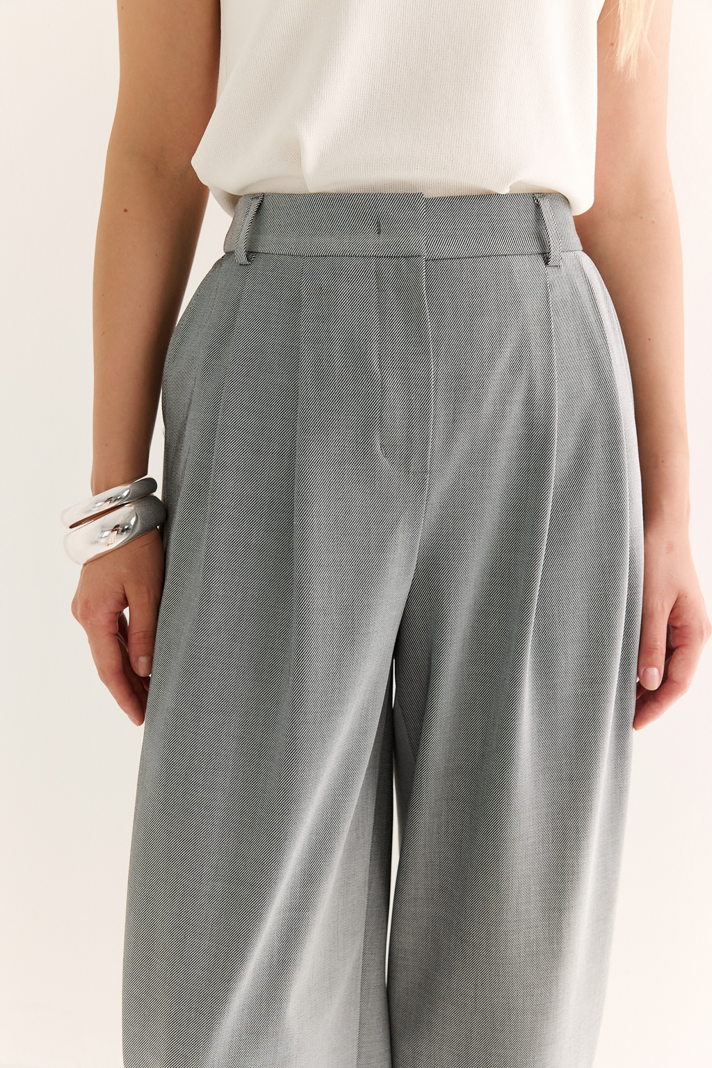 Брюки-бананы: акцент на форму, свобода в движении

Брюки силуэта "банан" — это смелый силуэт для тех, кто ценит индивидуальность и комфорт. Объём в области бедер создаёт модную линию, а зауженные книзу штанины визуально вытягивают силуэт и добавляют лёгкости образу.

Посадка по талии подчёркнута комфортной притачной резинкой сзади и складками спереди, что обеспечивает идеальную посадку по фигуре и делают модель уместной как в повседневных, так и в более строгих комплектах.

Сочетаются с топами, жакетами, рубашками и объемными худи — идеальная база для капсулы в стиле smart casual.

Модный акцент с комфортной посадкой — каждый день по-новому.