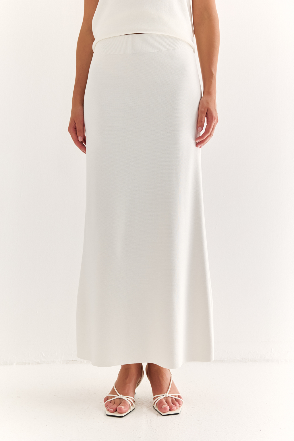 Юбка силуэта трапеции длиной миди.