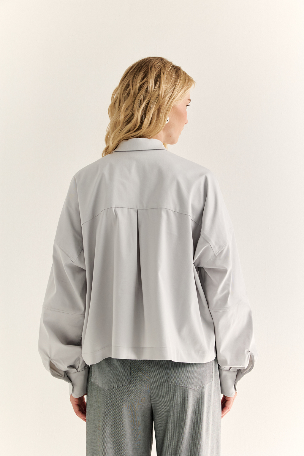 Oversize-рубашка: свобода в форме, точность в деталях

Эта укороченная oversize-рубашка — воплощение современного кроя и функционального стиля. Объёмные рукава с манжетами, акцентная застежка и выразительная спинка с декоративными элементами придают образу архитектурность и остроту. Маленький воротник и прямой  крой делают модель универсальной — от smart casual до модного street style.

Носите как самостоятельную вещь или как верхний слой поверх топа и платья. Особенно эффектно сочетается с брюками-карго, юбкой на высокой талии или джинсами.

Для тех, кто выбирает стиль с воздухом