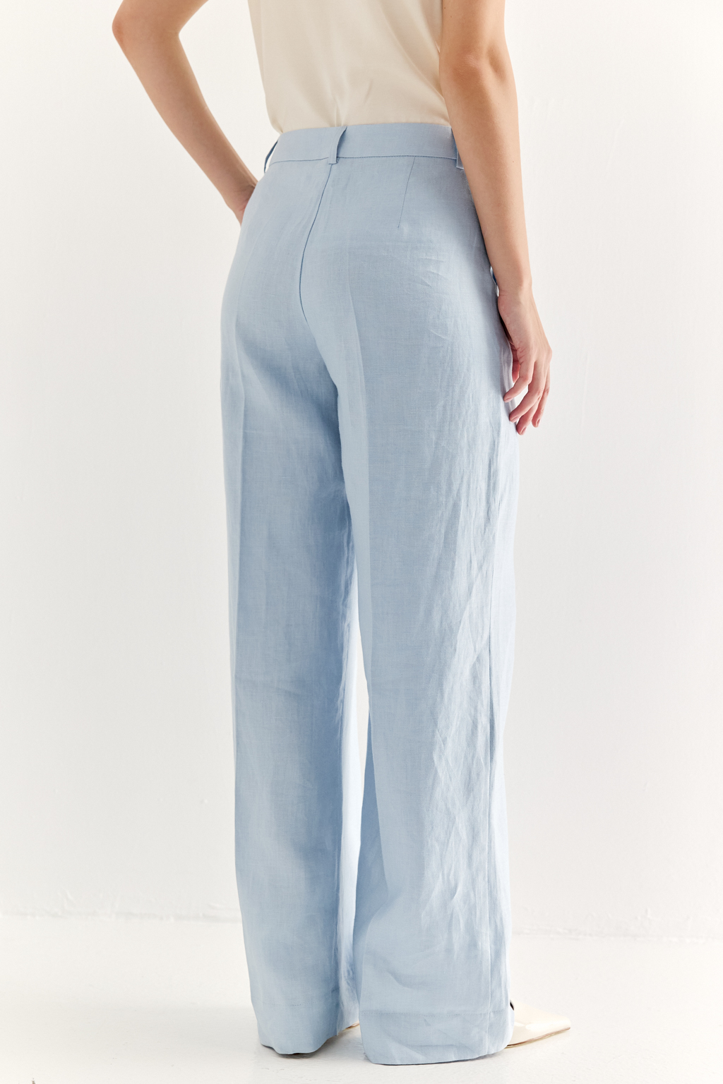 Эти брюки прямого силуэта созданы для абсолютного комфорта и расслабленной элегантности. Выполненные из ткани премиум-класса в нежном акватически голубом оттенке, они дарят невероятное ощущение мягкости и комфорта. Состав: стопроцентный льняной твил с эффектом air wash. В дизайне этих брюк нашли отражение элементы мужского кроя: застёжка-гульфик, пояс со шлевками и удобные карманы. Широкая подгибка позволяет регулировать длину брюк посредством отворота-манжета, создавая элегантный акцент по низу. Брюки идеально дополнят городской look с льняным жакетом и трикотажем.
