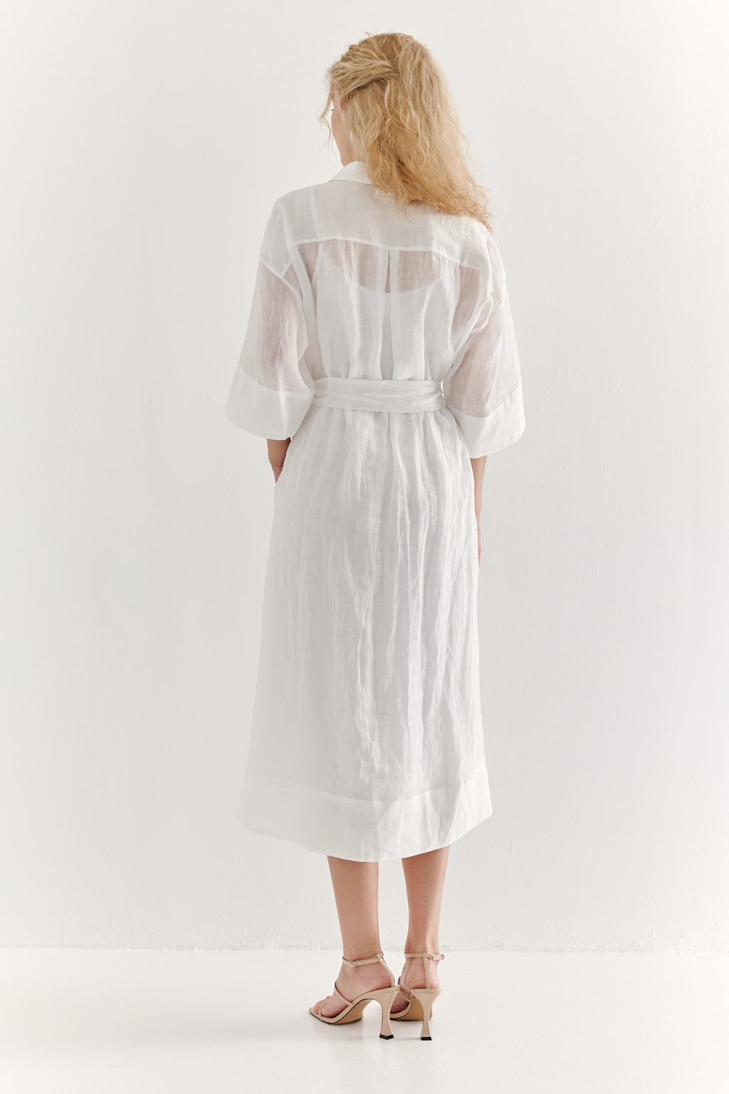 Это комфортное платье – традиционный образ для жаркого летнего дня. Платье изготовлено из воздушной невесомой вуали молочного цвета, в составе которой комфортный и экологичный материал крапива. Отложной воротник, планка для застежки, кокетка спинки, втачной широкий рукав одна вторая с отворотом, притачной бордюр по низу платья, пояс-самовяз и трапецивидный силуэт создают максимально комфортное образ. Возможно создание естственного крэш-эффекта, платье не требует сложного ухода.