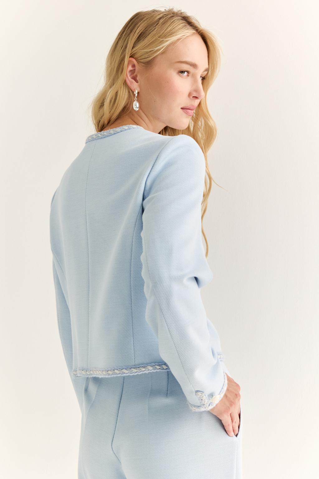 Жакет в стиле Chanel: вечная классика с характером. Икона женственности в новом прочтении — жакет в стиле Chanel с характерными элементами: округлым вырезом, выразительной декоративной тесьмой и крупными акцентными пуговицами. Прямой укороченный силуэт подчёркивает линию талии и делает модель идеальной как для офисного образа, так и для изысканного вечера. Накладные карманы добавляют практичности и шарма, а отделка по борту и рукавам формирует изящную рамку силуэта. Носите с юбкой, джинсами или брюками — он добавит статусности в любой комплект. Легендарный силуэт. Современное звучание.