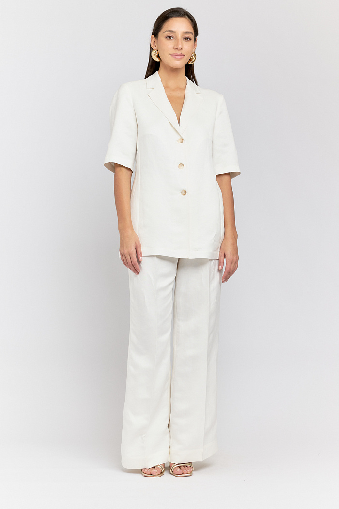 Брюки с защипами свободного кроя со стрелками. Застежка на пуговицу и молнию.