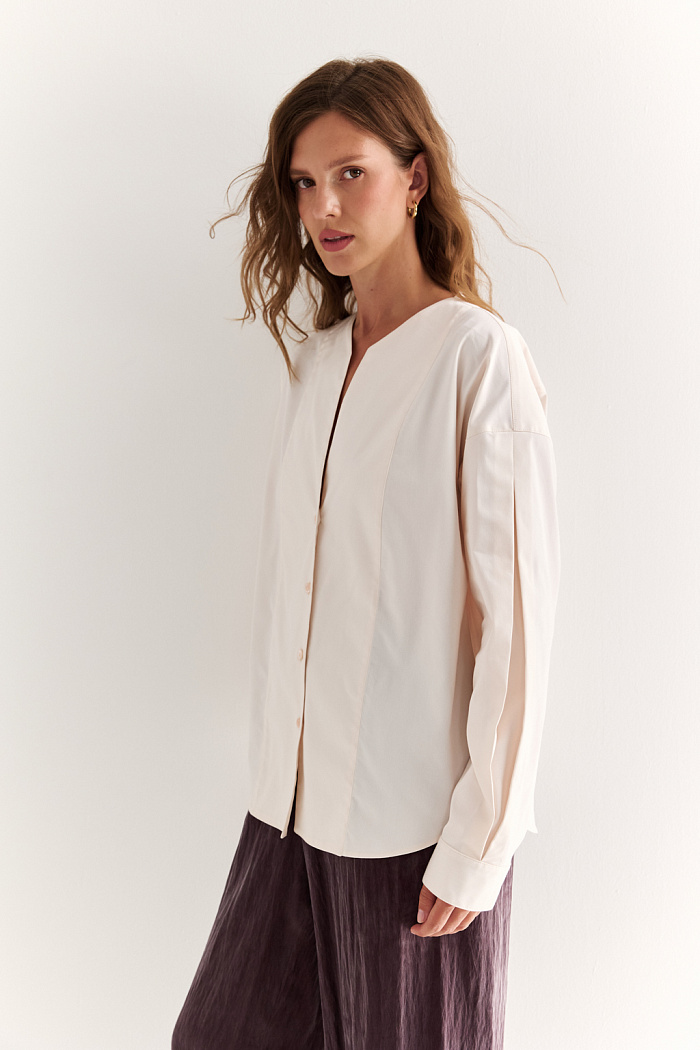 Блуза с V-вырезом: нежность в современном ритме. Эта блуза сочетает в себе деликатность форм и продуманную простоту. Глубокий V-образный вырез визуально вытягивает силуэт, а мягкие линии кокетки и рукавов добавляют романтичности. Объёмные рукава с манжетами и аккуратная застёжка на пуговицы завершают образ с лёгкой винтажной ноткой. Идеально смотрится в паре с юбками на высокой талии, широкими брюками или под жилет. Благодаря универсальному дизайну легко вписывается как в деловой, так и в вечерний гардероб. Лёгкость, которая подчёркивает внутреннюю силу.