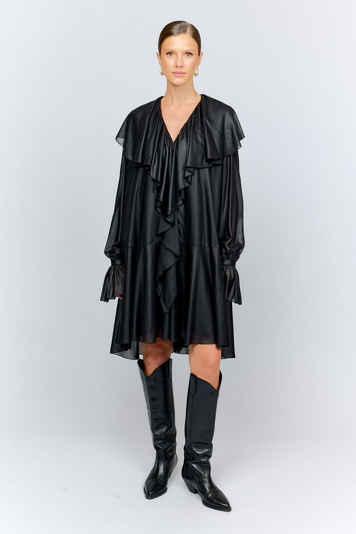 Платье в бохо-стиле из легкого шифона с глянцевым напылением, создающим эффект кожи свободного расклешенного силуэта. По вороту широкие воланы переходят в струящиеся линии спереди почти до самого низа платья. Рукава обьемные на манжетах с застежками и длинными рюшами. Платье состоит из двух элементов: само платье и комбинация-подклад.