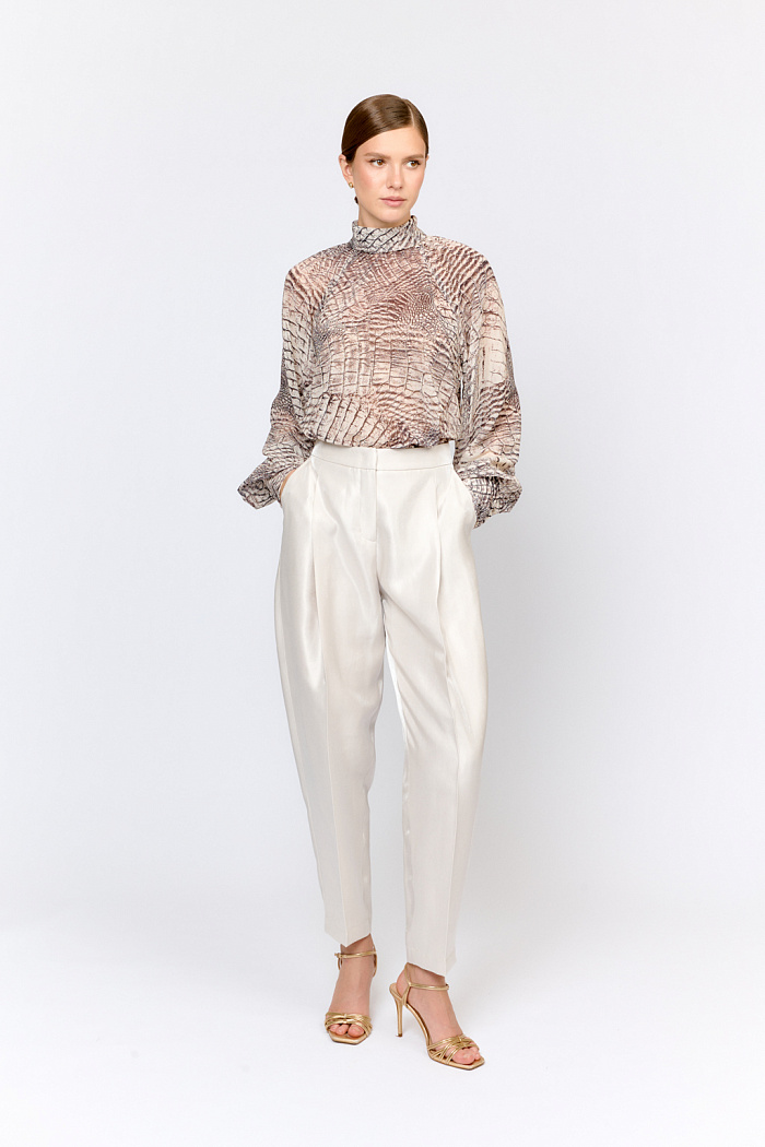 Брюки свободного кроя с широкой складкой спереди и заужением книзу. В этой модели модный силуэт сочетается с трендовой тканью, создавая современный образ. Брюки можно комбинировать с корсетом с баской из аналогичной ткани или сочетать с блузами, вязаным трикотажем, базовыми боди из коллекции. Эффектная ткань из района в жемчужном цвете дополняет  четкость архитектурных линий кроя. Брюки могут стать акцентной  основой  нарядного образа для торжественного вечера  или стильного ужина. Преимущества ткани: район, волокно натурального происхождения, отвечает за приятные тактильные ощущения, комфорт при носке и пластичность. Нейлон придает структурность и износостойкость. Полиэстер обеспечивает легкость в уходе. Эффектная, приятная к телу ткань с актуальной фактурой для создания современных образов.