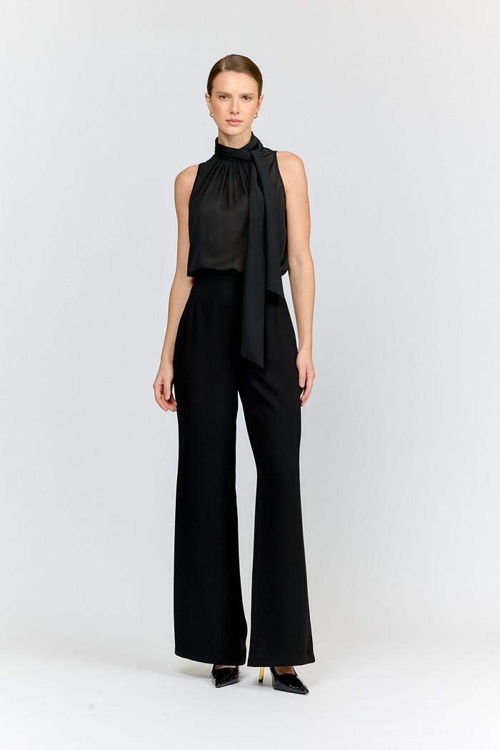 Брюки-клёш из роскошного матового черного крепа. Узкий пояс и элегантная посадка на талии формируют женственный силуэт. Идеальны для создания вечерних аутфитовв комплекте с жакетом из такой же ткани.