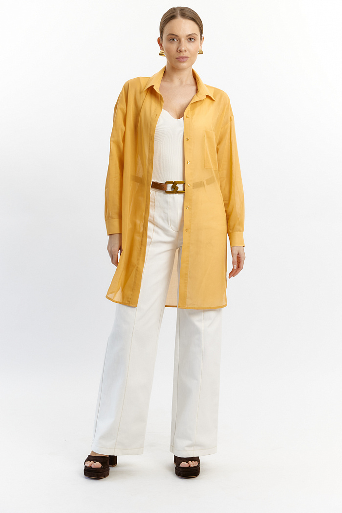 Блуза удлиненная до колен свободного кроя с закругленным низом. Рукав полной длины на манжете. Спереди одни накладной карман.